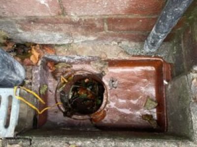 Damaged gully pot in Bury with debris and poor drainage, removed and replaced with a new gully.