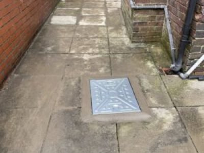 New manhole cover installed after collapsed drain repair in Oldham