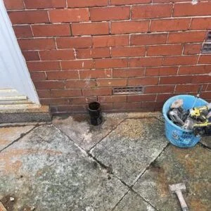 Exposed soil pipe opening before drain repair work begins