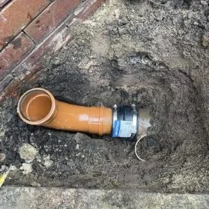 Underground drain pipe repair using a coupling connection