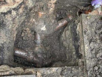 Exposed underground pipework causing repeated downstairs toilet blockages in Rochdale.