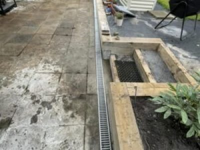 Installed ACO channel drain along patio edge for improved surface water drainage in Sale, Trafford.