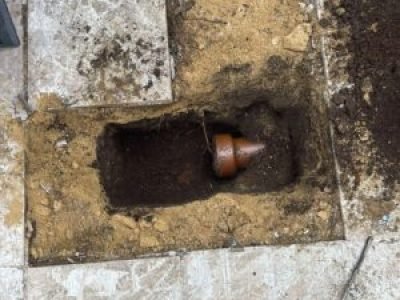 Drain outlet excavation ready for connecting ACO channel drain to underground pipework in Sale, Trafford.